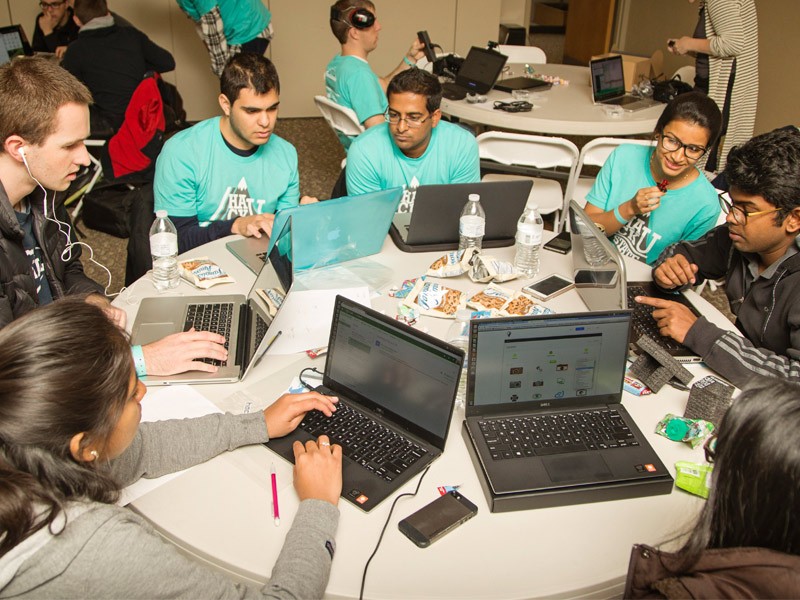 students gathered around their computers